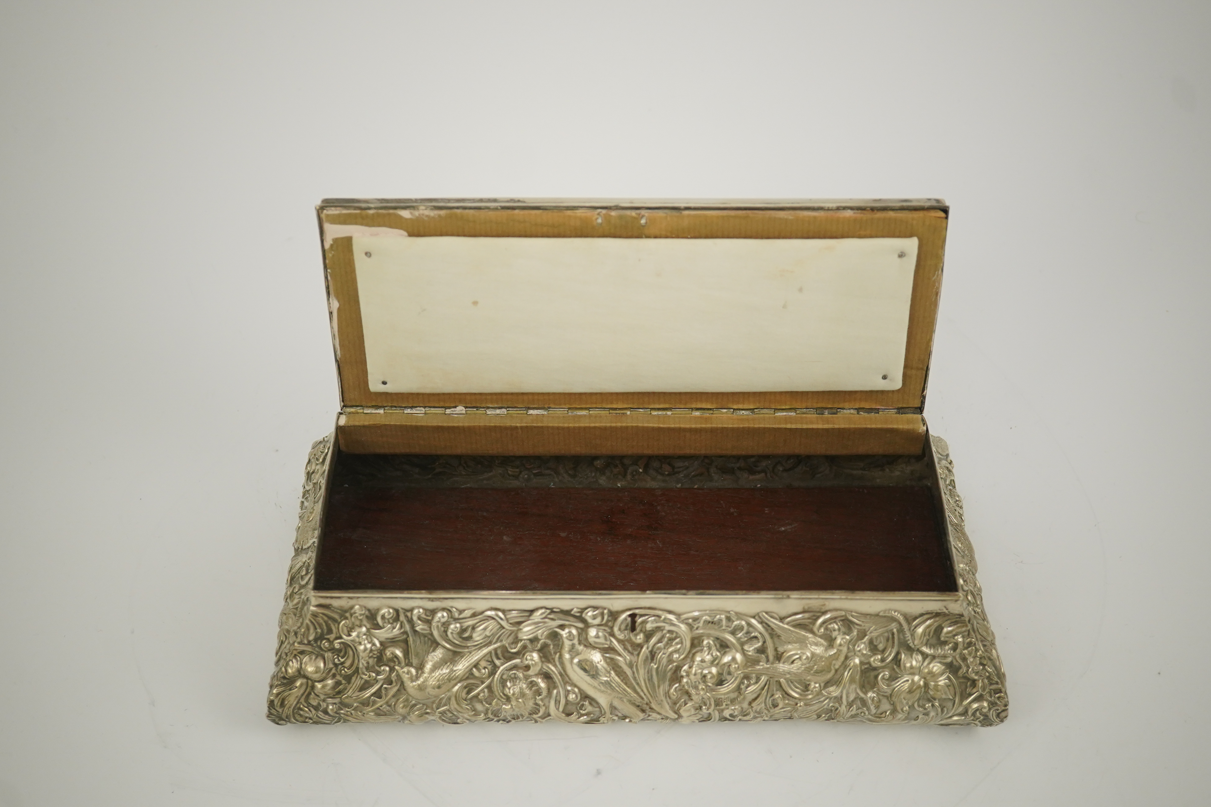 An Edwardian repousse silver mounted jewellery casket, by William Comyns